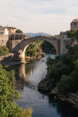 Fototapeta na wymiar Mostar, Bosnia and Herzegovina - September 12 2021:View over Mostar Bridge - Stari Most during a sunny day, famous touristic destination in Bosnia and Herzegovina, Europe