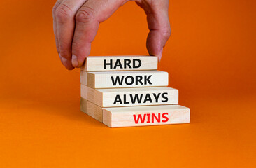 Hard work always wins symbol. Concept words 'Hard work always wins' on wooden blocks on a beautiful...