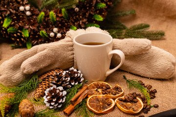 Fototapeta na wymiar Beautiful stylish christmas composition with a cup of tea, cinnamon and pine cones 