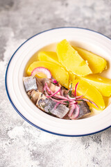 herring and potatoes boiled vegetable second course marinated fish onion fresh ready to eat meal snack on the table copy space food background 