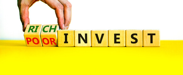 Rich or poor invest symbol. Businessman turns cubes and changes words poor invest to rich invest. Beautiful yellow table, white background, copy space. Business and rich or poor invest concept.