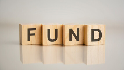 Four wooden cubes with letters Fund. Business marketing concept