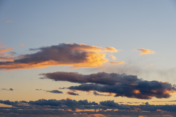 Fiery orange sunset sky. Beautiful perfect sky for your photos. Cloudscape of cumulus sunset clouds with sunlight
