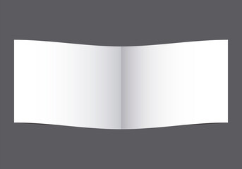 Libro abierto en página en blanco sobre fondo gris.
