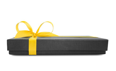 Black gift box (present) with yellow satin ribbon bow, side view, isolated on white background