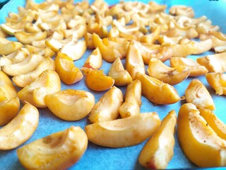 Yellow pieces of apricots on a blue background