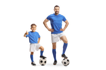 Fototapeta na wymiar Football coach and a boy with a soccer ball gesturing thumbs up