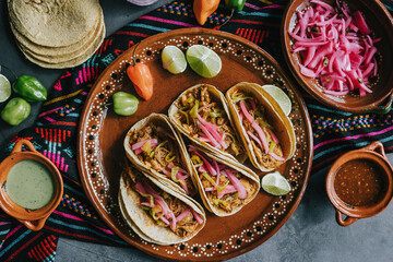 mexican tacos flat lay composition with pork carnitas, cochinita pibil, onion and habanero chili...
