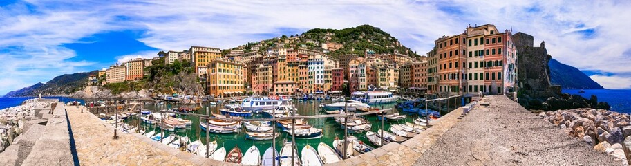 Fototapeta na wymiar Camogli - beautiful colorful town in Liguria, panorama with traditional fishing boats .popular tourist destination in Italy