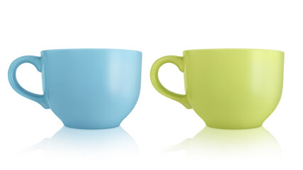 Ceramic cups. Two large empty ceramic mug isolated on white background. Mugs with a handle. Green and blue cups.