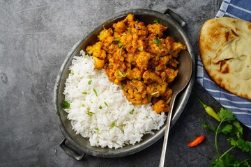 Cauliflower tikka masala or gobi curry served with rice and roti, selective focus - obrazy, fototapety, plakaty