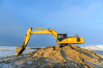 Yellow excavator working on construction site. The road construction. © Alexey Seafarer