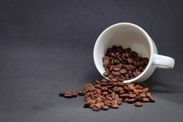 white cup of coffee beans with black background
