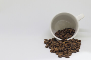 white cup of coffee beans with black background