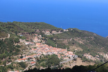 Fototapeta na wymiar Elba, Italy – September 01, 2021: beautiful places from Elba Island. Aerial view to the island. Little famous villages near the beaches. Summer tourist places. Clouds and blue sky in the background.