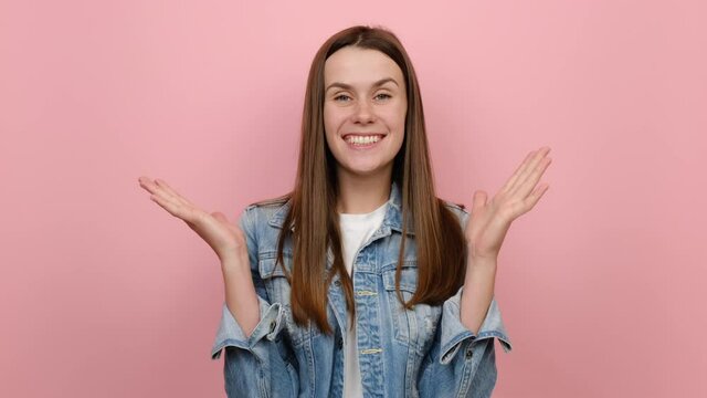 Side profile view young millennial woman 20s years old wears denim jacket turn around camera cover mouth with hands on face say wow omg no way, posing isolated over pastel pink color background studio