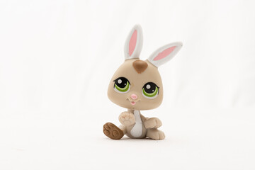 Plastic toy rabbit on white background.