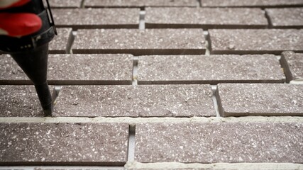 Close-up of a seam in a brick wall. Brown brick wall with cement joints close up. Brown brick wall.