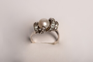silver ring with a pearl on a white background