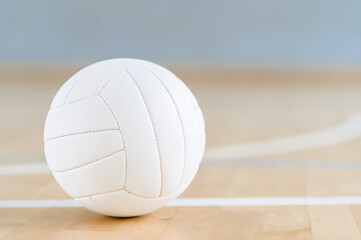 Volleyball ball and white line on wooden court. Horizontal education and sport poster, greeting cards, headers, website