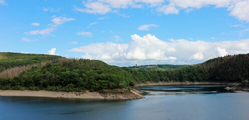 Wide view from the dam of the Urft river towards Vogelsang in the Nationalpark Eifel in Germany in summer