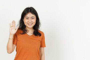 Waving hand Greeting Gesture of beautiful asian woman Wearing orange T-shirt isolated on white background