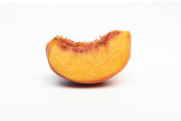One peach wedge, isolated on white background