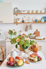 Autumn postcard. Thanksgiving Day. Halloween. White kitchen with pumpkins and flowers. Harvest background