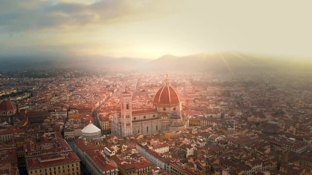 Aerial Drone View: Historically and Culturally Rich Italian Town Florence at sunrise. Beautiful Old City With Medieval Churches and Cathedrals. River Runs through the City in 4k. Florence skyline.
