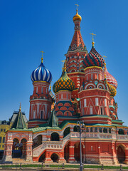 Fototapeta na wymiar Colorful domes of the St. Basil's Cathedral on a spring sunny day with blue sky. Red square in Moscow, capital of Russia. Tourist places of Moscow in summer travel to Russia.