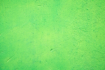 Subdued pale neon green painted house wall, exterior or interior decoration, with texture and large empty text space.
