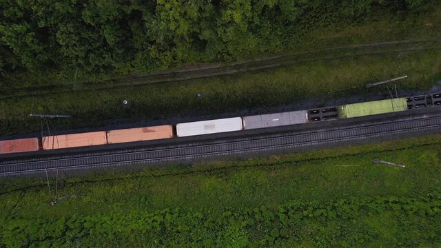 Cargo Containers Transportation On Freight Train By Railway. Intermodal Container On Train Car. Rail Freight Container Shipping. Logistics Concept on railroad. Import - export goods from Сhina.
