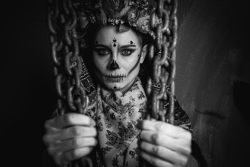 Happy Halloween concept. Portrait of a horrible woman in a special outfit, wearing professional...
