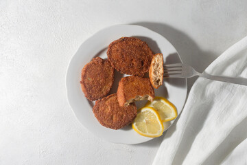 Ready fried fish cakes from caviar. Bright orange on a white background.