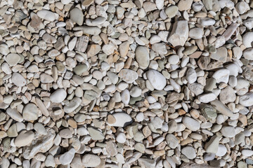 Ionian sea pebble marble stone beach close-up texture. White and beige colors rocks in Greece, Lefkada island coast