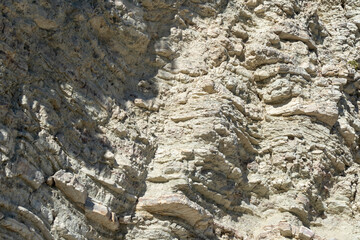 White layered rocks texture, geology close-up, coast of Lefkada island in Greece. Wild natural material surface close-up