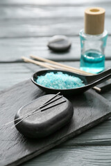 Obraz na płótnie Canvas Acupuncture needles and spa stone with sea salt on table