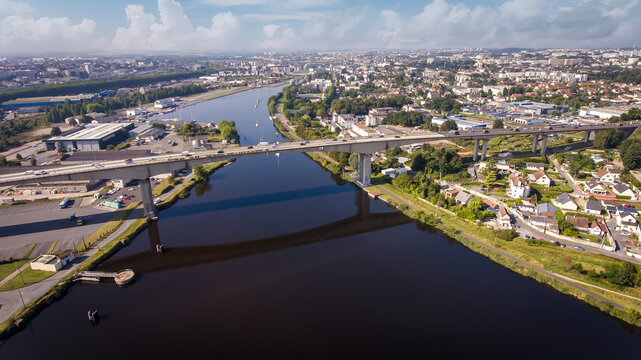 CAEN, FRANCE-SEPTEMBER 2021: Viaduc de Calix on the canal de caen. The largest bridge in Caen, an important road for cars. A photo from the drone, in the phone is buildings and greenery