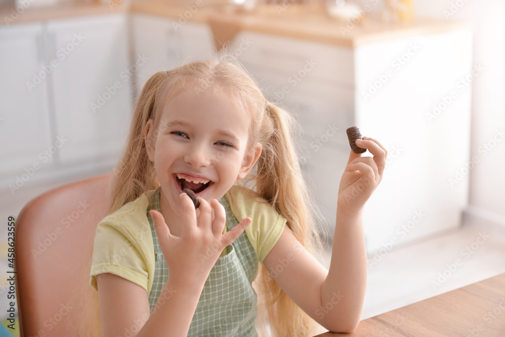 Sticker cute little girl eating sweet chocolate in kitchen