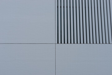 Background: closeup of modern spirit architecture, with white metal facing plate and striped window covering