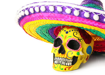 Painted human skull for Mexico's Day of the Dead (El Dia de Muertos) and sombrero on white...