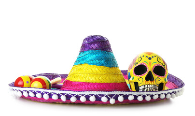 Painted human skull for Mexico's Day of the Dead (El Dia de Muertos), maracas and sombrero on white...