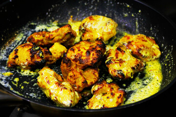 zafrani chicken tikka, saffron and yoghurt marinated spiced tandoori chicken cubes glazed with cream, indian cuisine.