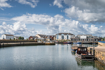 Sailboats and fishing boats moored in small, beautiful marina in Carrickfergus town, Northern Ireland