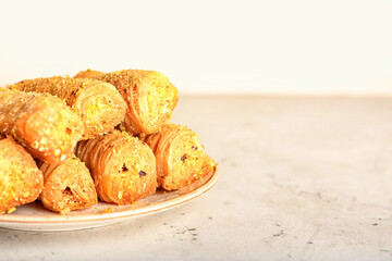 Plate with delicious baklava on table