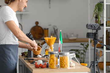 Italian chef with mortar and pestle in kitchen