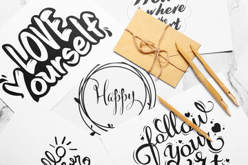 Dip pens and envelope on paper sheets with different texts