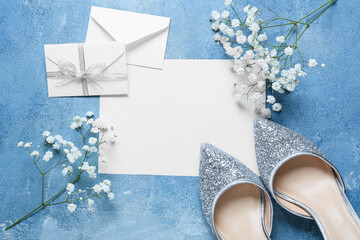 Blank card with envelopes, flowers and shoes on blue background