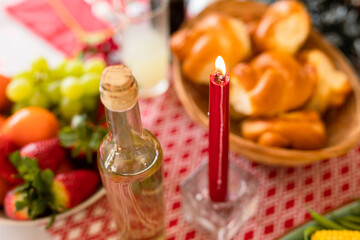 Bottle, candle and traditional dishes lying on christmas table