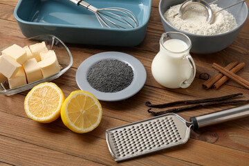 Ingredients for delicious muffins with poppy seeds on wooden table
